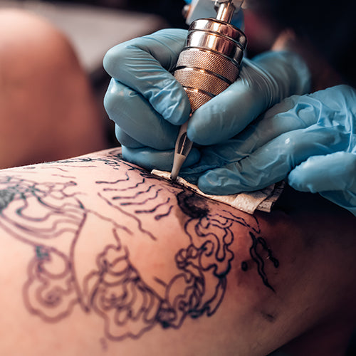 Close up of a tattoo artist at work