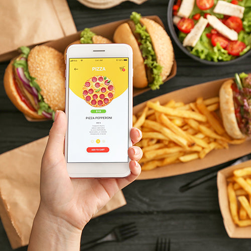 Woman with mobile phone ordering from a food delivery app